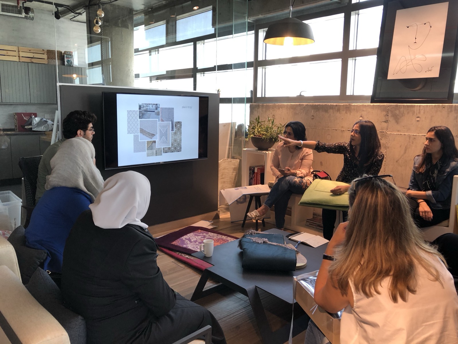 Business owners working through their online catalogues with an Umbrella500 trainer during the World Bank programme in Amman, Jordan